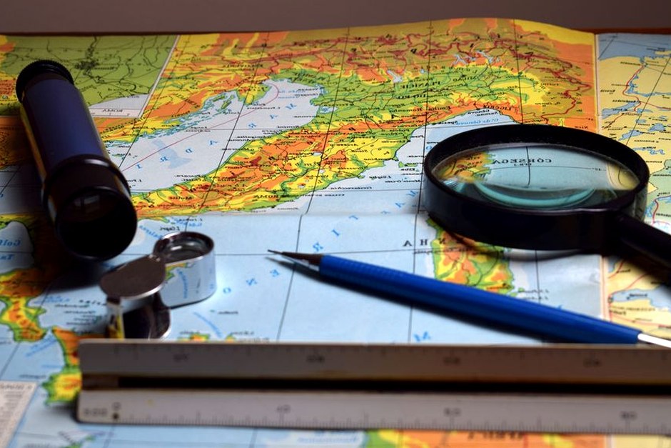 A map and simple tools arranged for close visual reference.