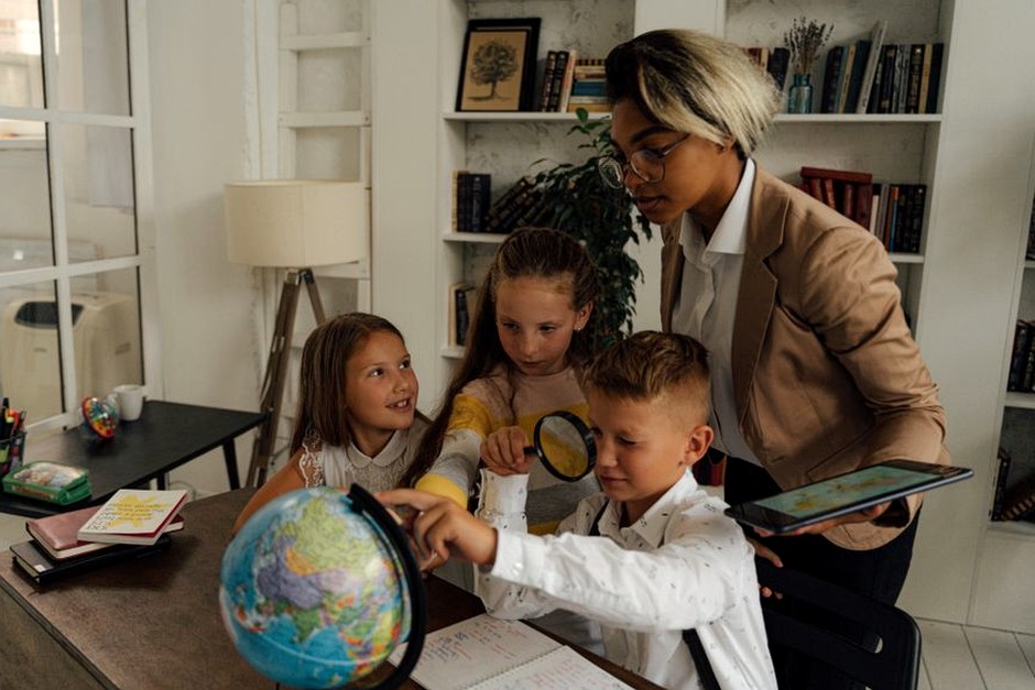 People exploring ideas together around a globe in a bright home setting.